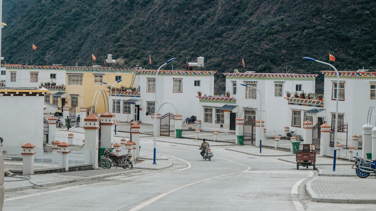 Picturesque scene of vibrant traditional village houses lining a quiet street, showcasing cultural architecture.